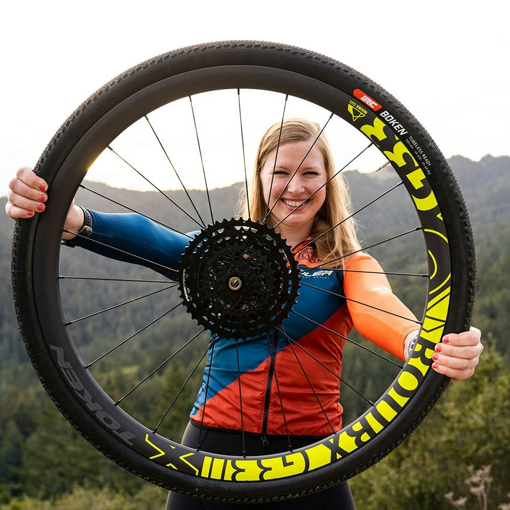 Voler Gravel Team - Michelle Hance holding a carbon gravel rear wheel