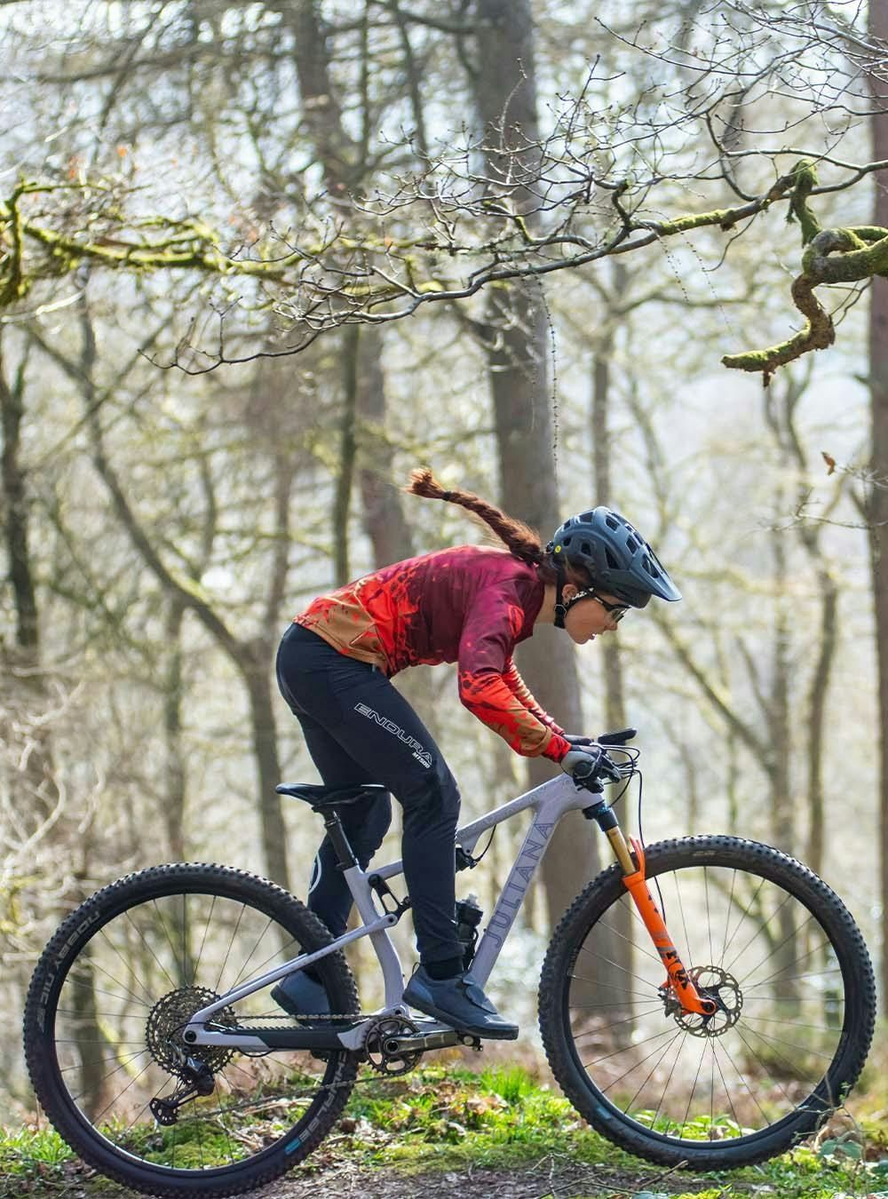 Juliana Bicycles Pro XC Athlete: Isla Short riding on a singletrack trail in the forest