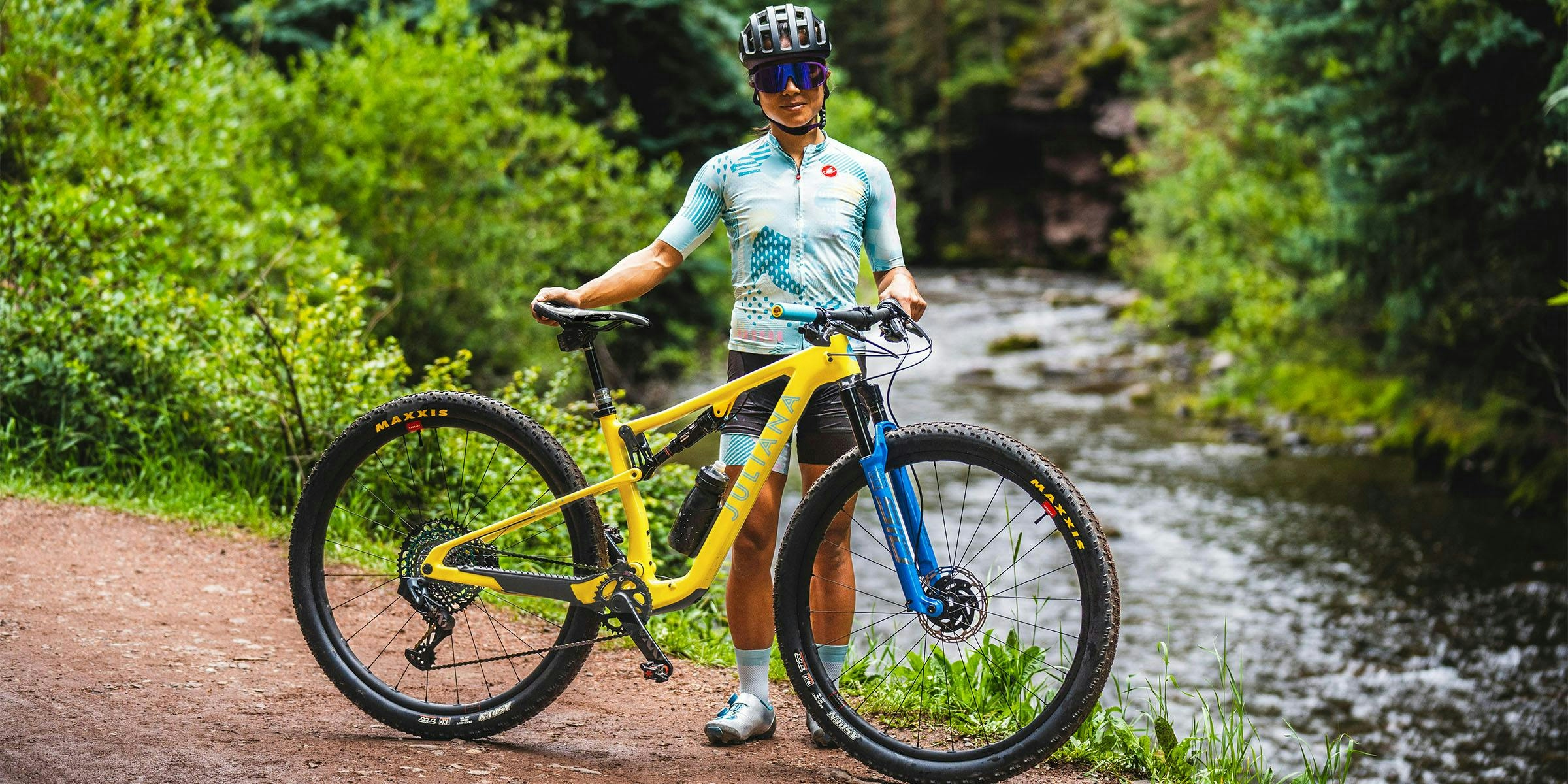 Juliana Bicycles Pro XC Rider - Evelyn Dong standing with her Wilder X01 AXS RSV Full Suspension Mountain bike